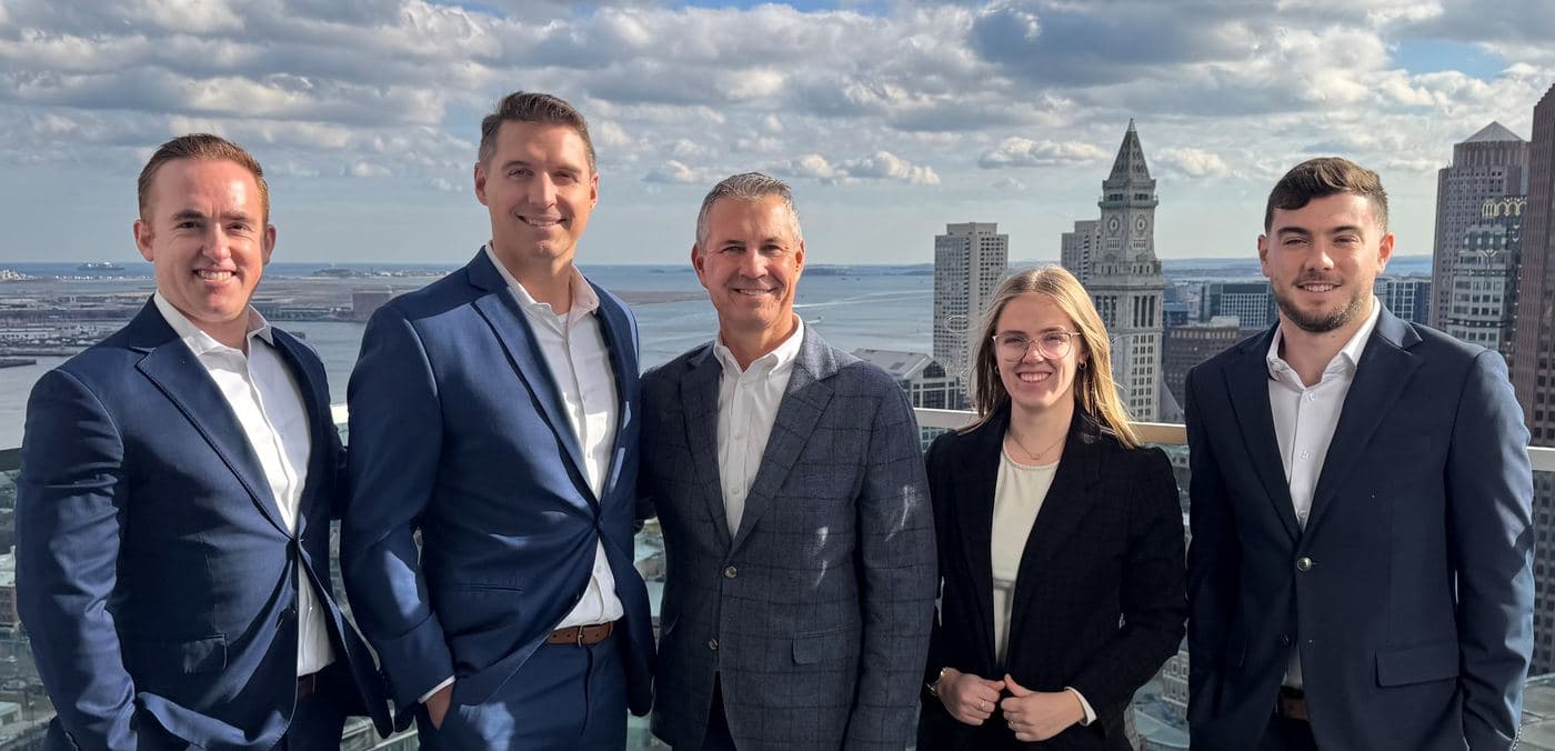 Craig Haba and Ben Sherry with the team at Raymond James, on a rooftop overlooking Boston's Financial District.