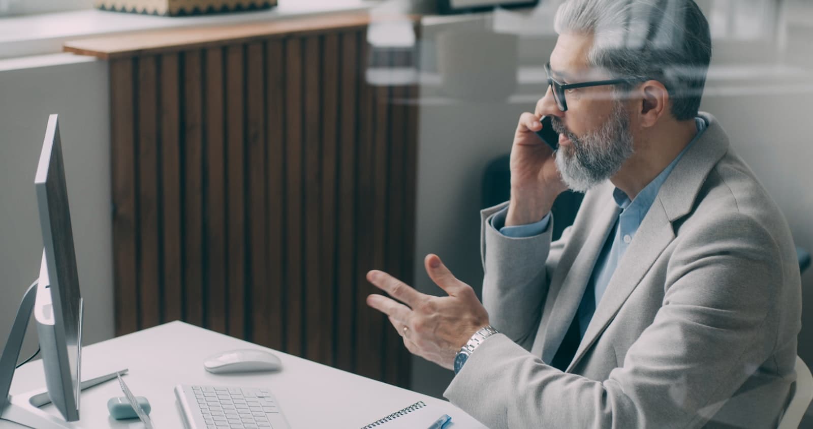 A senior advisor at his desk, taking a private phone call